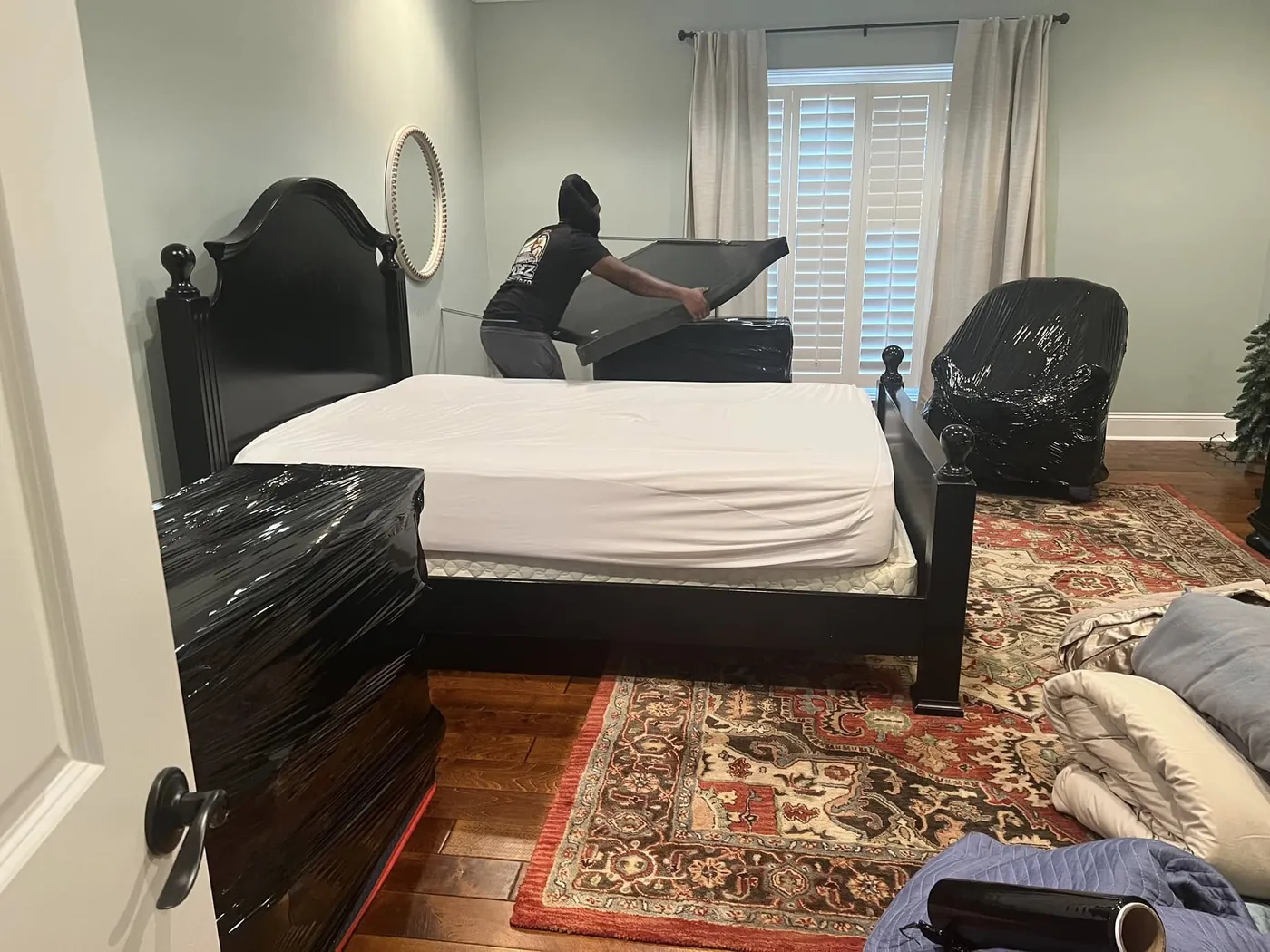 Furniture wrapped in moving blankets and protected by Perez Moving Co